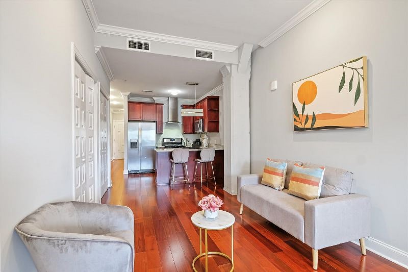 This beautifully spacious living room blends modern elegance with cozy charm, featuring clean lines, soft tones, and an abundance of natural light. It's a serene space designed for both effortless relaxation and stylish gatherings.