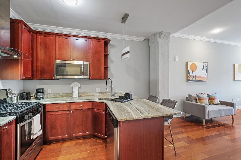 This airy, open-concept kitchen combines sleek design with everyday functionality, showcasing elegant finishes, ample counter space, and warm natural light. It's the perfect blend of style and practicality, ideal for both cooking and connection.