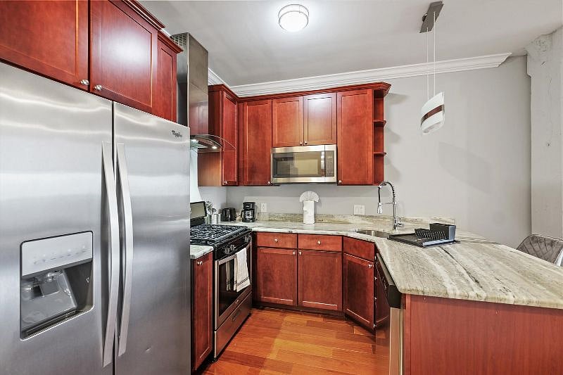 This airy, open-concept kitchen combines sleek design with everyday functionality, showcasing elegant finishes, ample counter space, and warm natural light. It's the perfect blend of style and practicality, ideal for both cooking and connection.