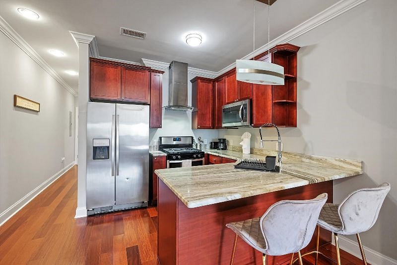This airy, open-concept kitchen combines sleek design with everyday functionality, showcasing elegant finishes, ample counter space, and warm natural light. It's the perfect blend of style and practicality, ideal for both cooking and connection.