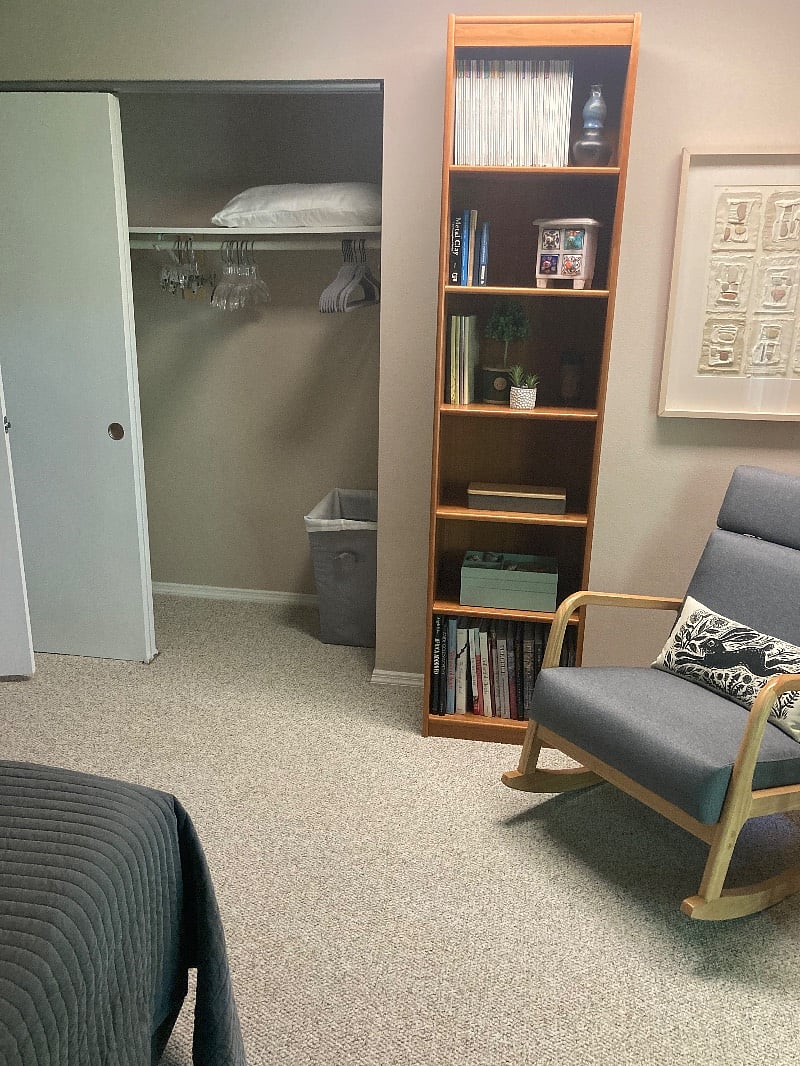 Bookshelf, ample closet storage, clothes hamper in rental space.
