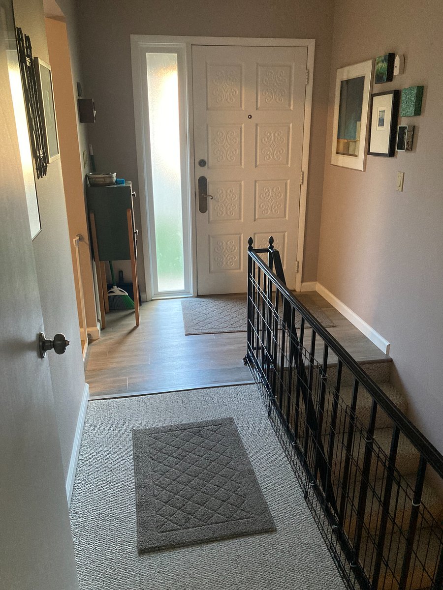 Front door, shared entrance.
Kitchen to left has barn door and dog gate to close off renter from landlord's space. Also door at end of upper hallway. So, basically a private entrance.