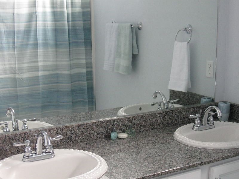 Upstairs bathroom with jetted tub and double sinks.