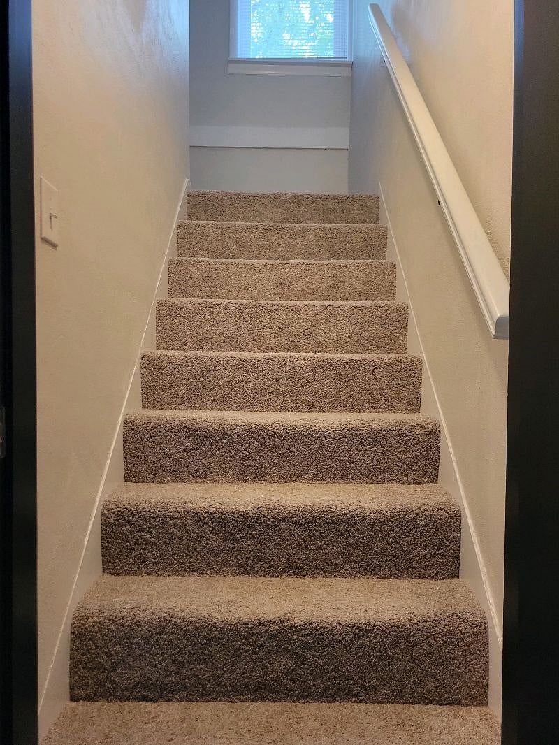 Stairway accessing second level great room & 3rd bedroom
