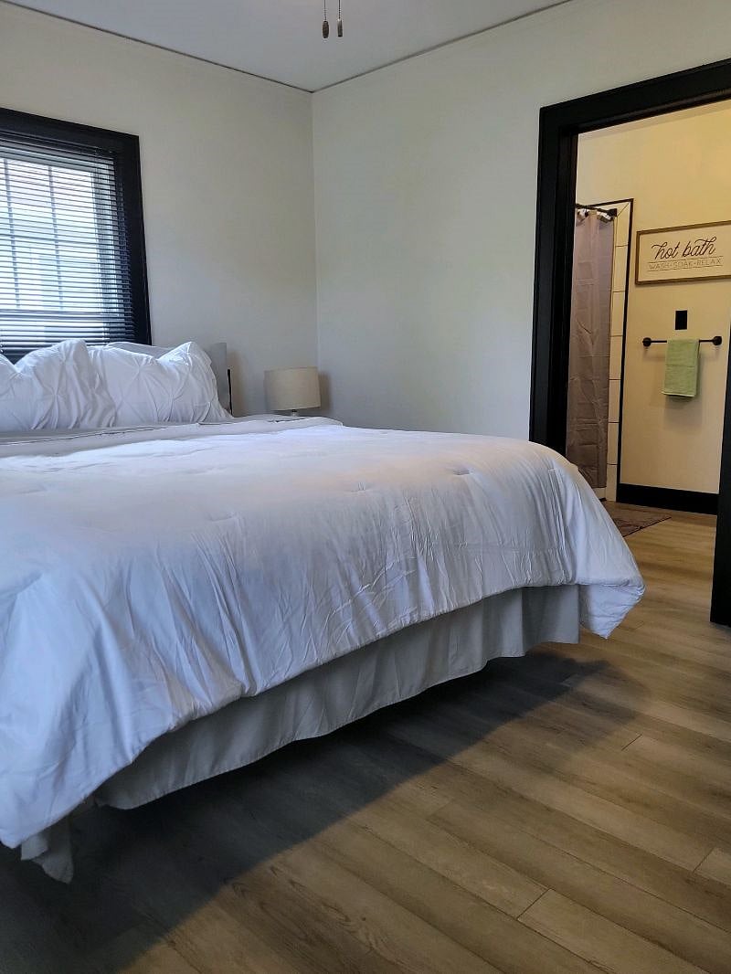 Bedroom 1 with main bath private entrance in background