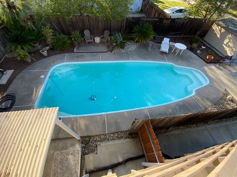 view of pool from carriage house entry