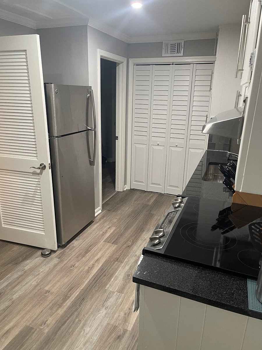 Eat in kitchen with stove, refrigerator, and coffee bar that extends to a full sized table/ desk.