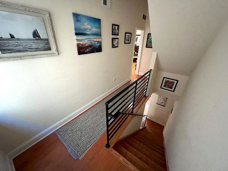 Stairs are wood-floor with railings.
