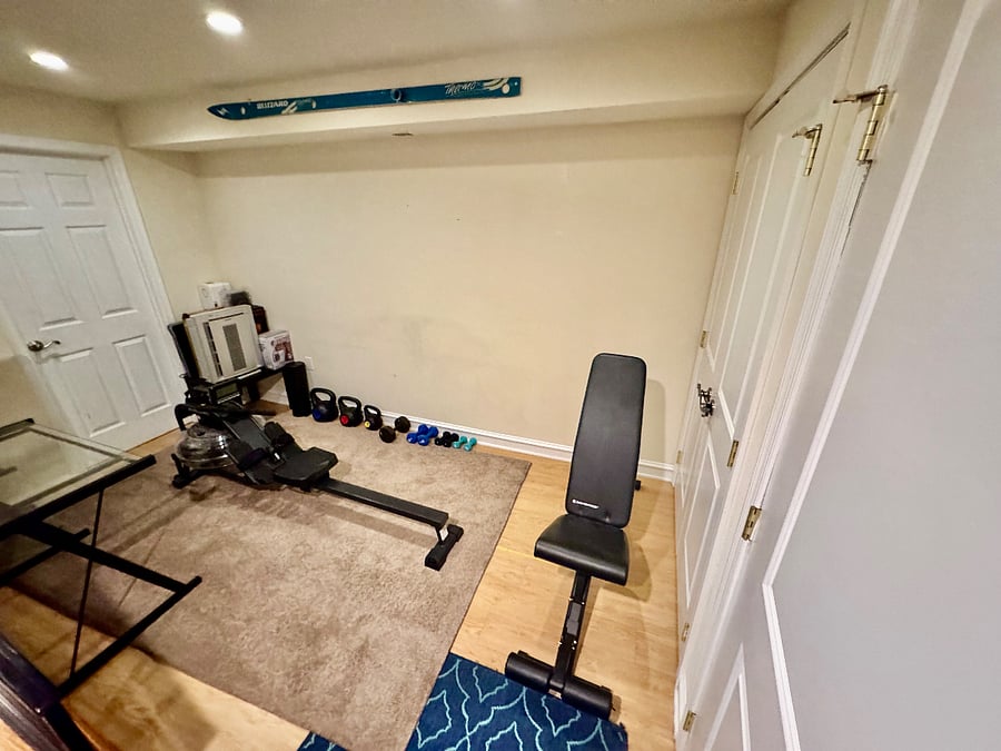 Finished basement with gym equipment. Currently other side of basement is storage, access to full bathroom