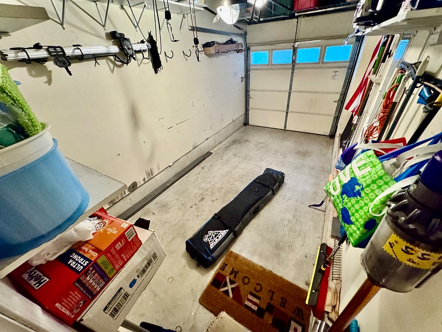 Full-size garage with access to street. Lots of shelving for paper goods, cleaning supplies, and other storage needs.