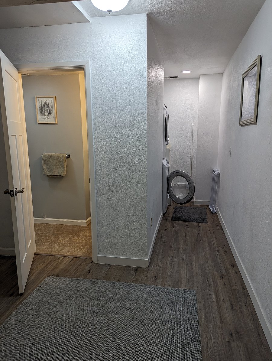 Laundry and bathroom in the hallway directly across from the bedroom door.