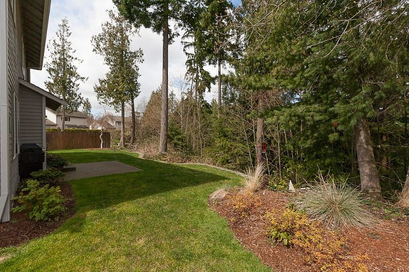 Backyard opening to greenbelt with walking trail below. BBQ available for use.