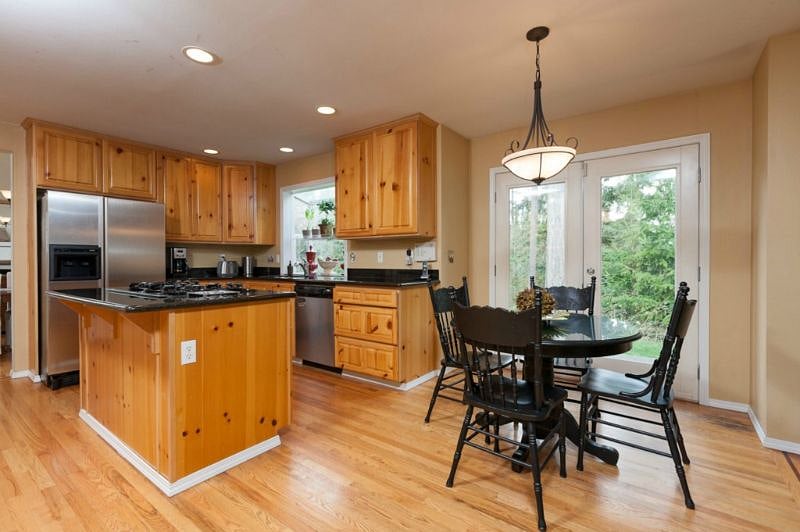 Knotty pine cabinets with shared fridge and pantry. Roommates are responsible for cleaning their own dishes or rotating dishwasher emptying/filling.