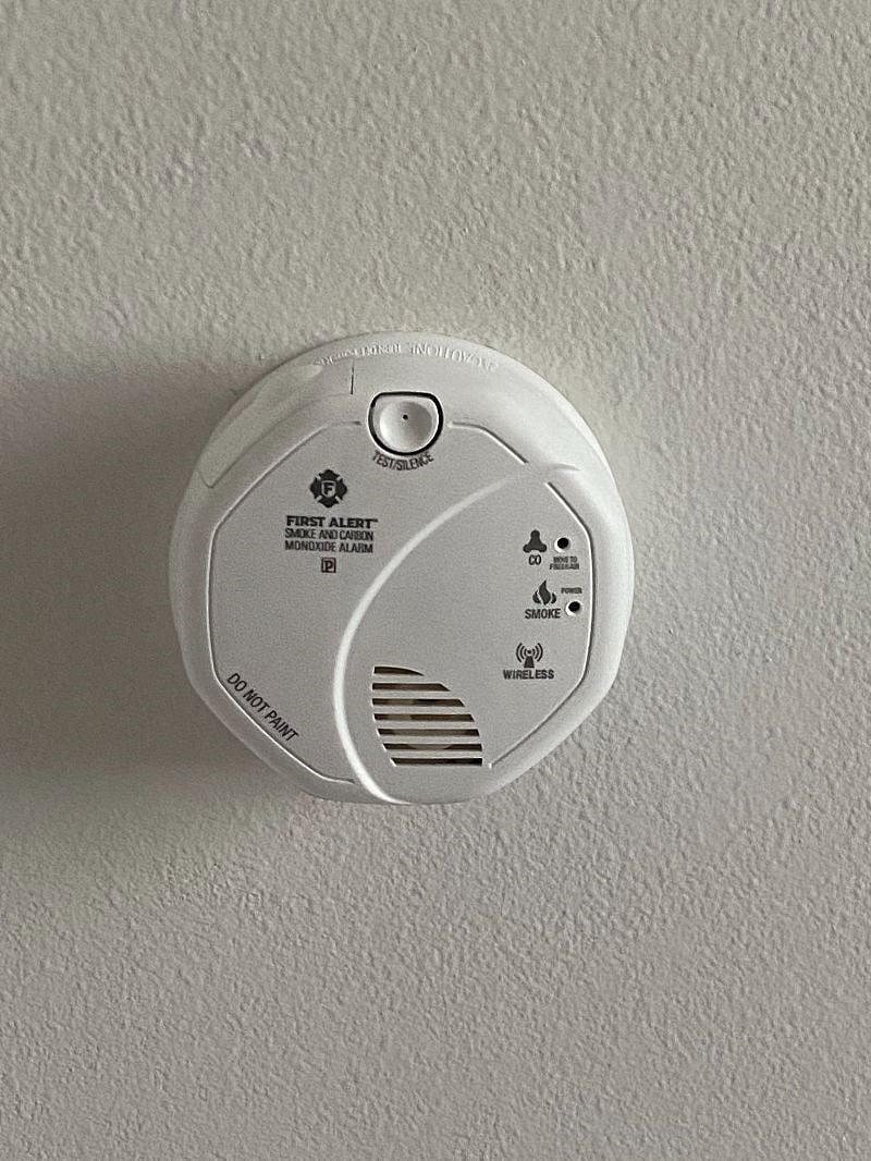 Dual smoke/carbon monoxide detector links to alarm system.