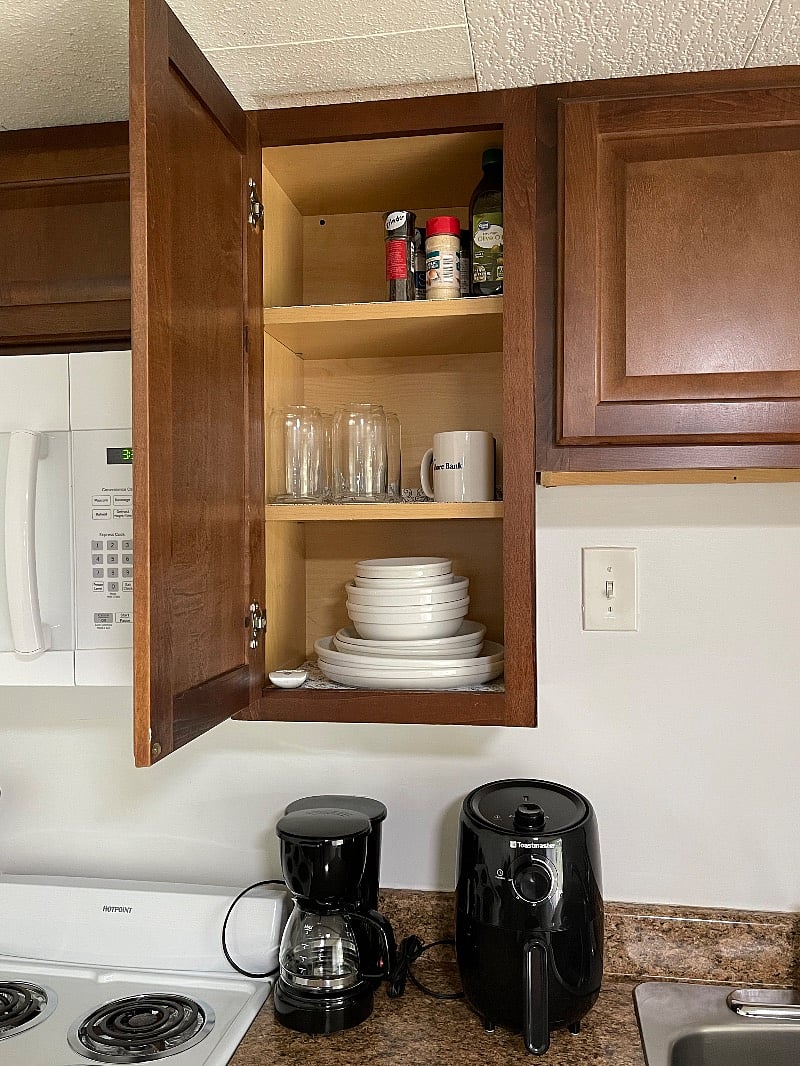 Stocked kitchen - dishes, glasses, pots and pans