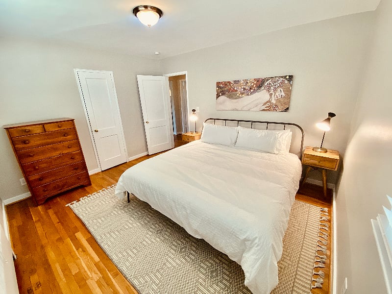 Primary bedroom with king-sized bed and walk-in closet.