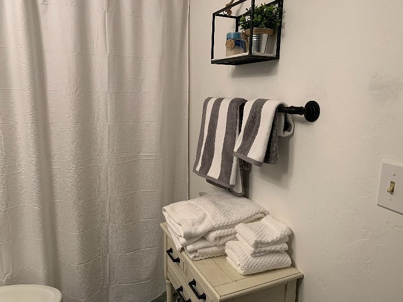 Full bath with tub/shower combo and built in Washer/Dryer in closet