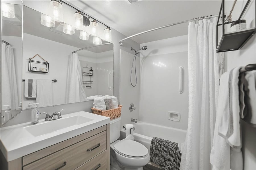 Nice sized bathroom with shower/tub and hand held shower head. New shower curtains always for new tenants. Small sink cabinet has space for your personal items.