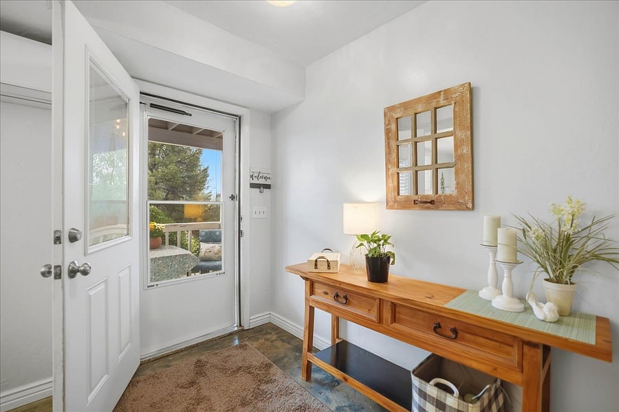 Private gated entry and small covered porch with table and chairs and a screen door with glass/screen and front door with glass and interior shade for privacy!