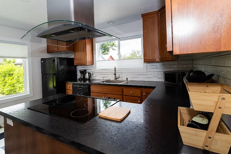 Induction stove. Lots of small appliances & kitchen tools.