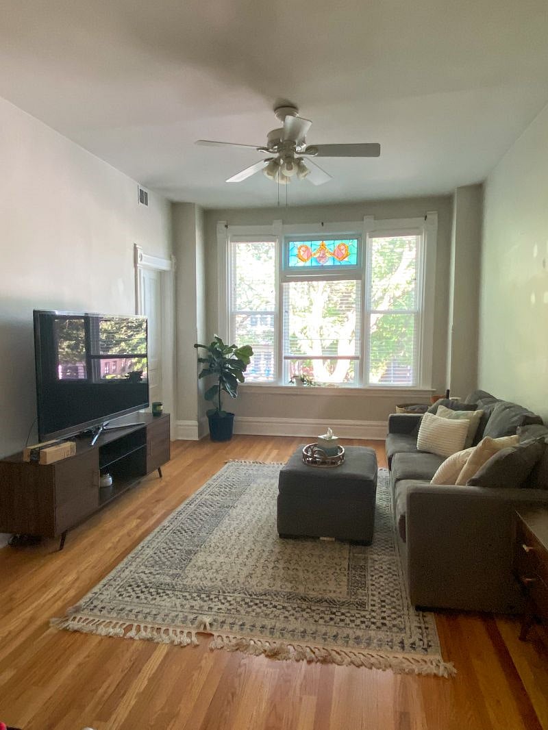 Living room with original stained glass window and large smart TV