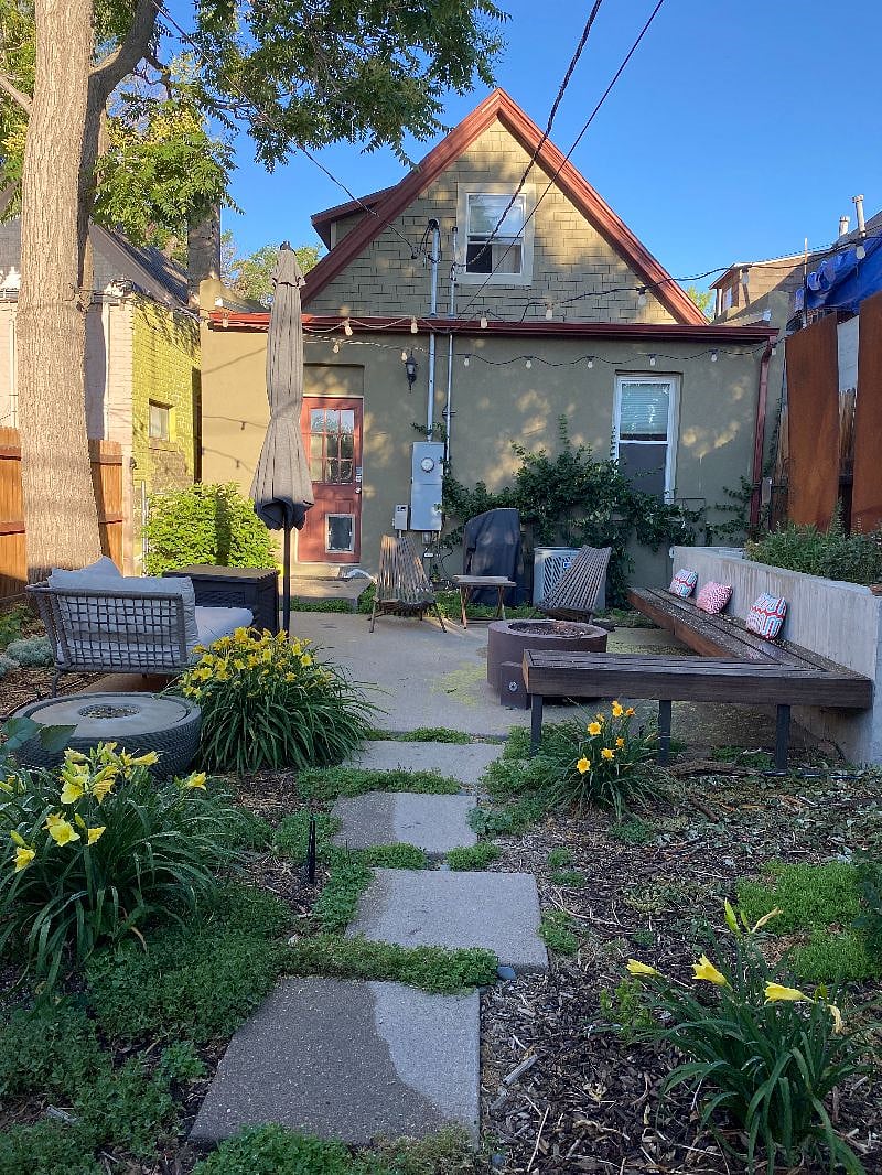 Outdoor living space complete with water feature, outdoor firepit and gas grill.