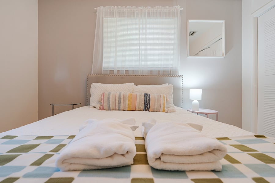 Stylish bedroom with a queen-sized bed, offering a serene escape after a long day.