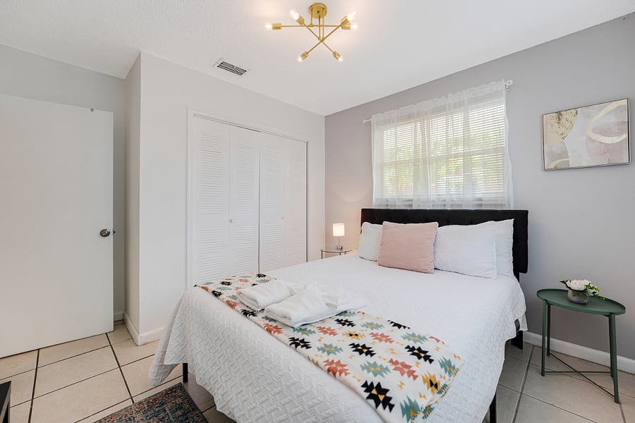 Second bedroom featuring a cozy queen-sized bed, perfect for family or guests.