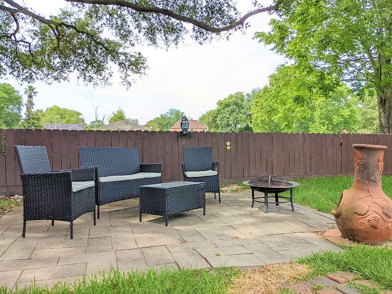 Shared space: Beautiful, well-maintained large fully fenced backyard with seating and lounge chairs for peace and quiet relaxation. 