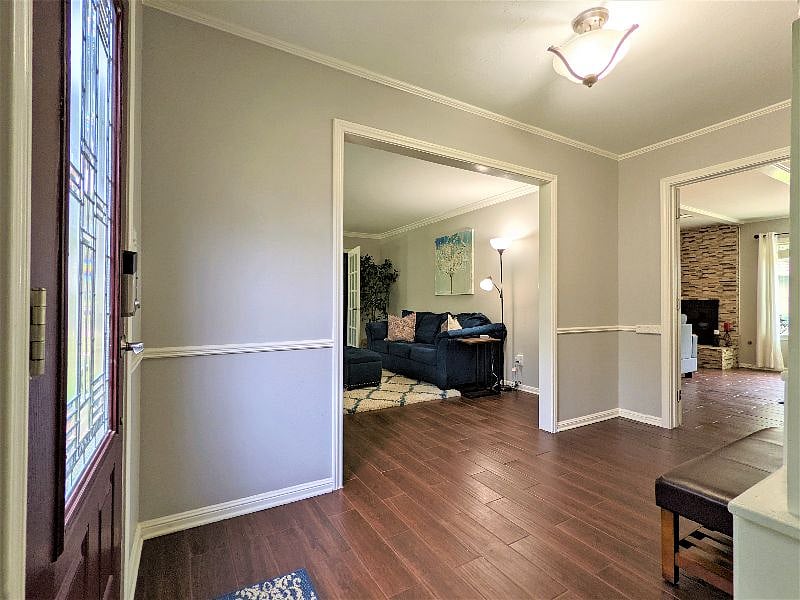 Shared space: Main entryway with second lounge living room to the left and living room with fireplace straight ahead