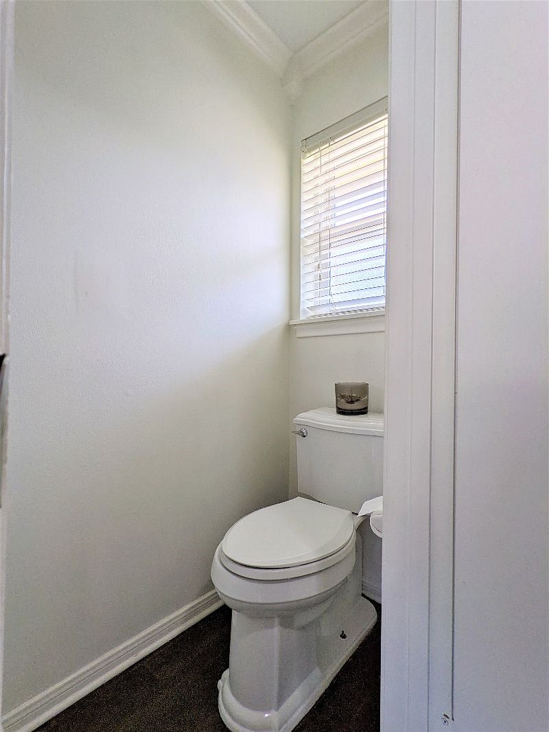 Shared space: Guest half bathroom inside utility room area