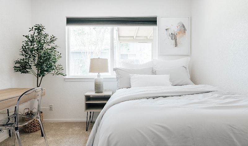 Bedroom 1 features a double bed, premium mattress, comfortable bedding and a working space
