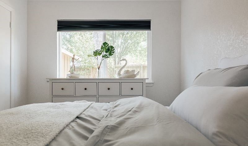Bedroom 2 features a double bed, new hybrid medium firm mattress, comfortable bedding, beautiful Ikea dresser and a large window with view to the fountain.