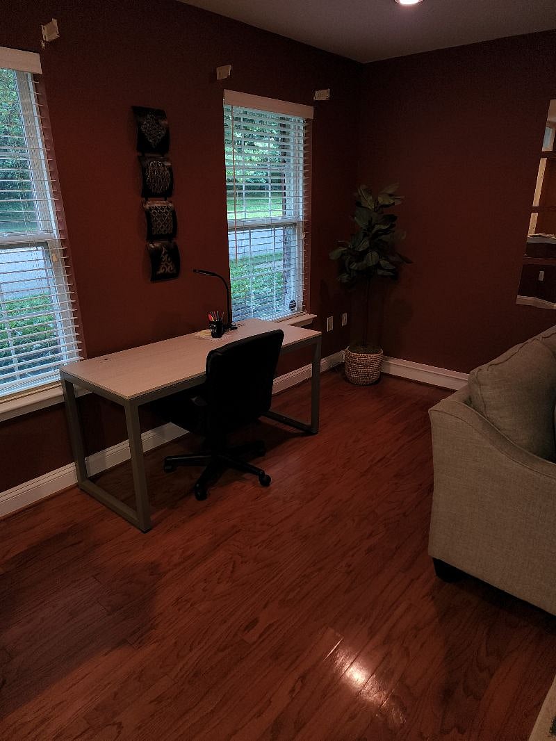 Office table/chair on 1st floor next to sitting area/den