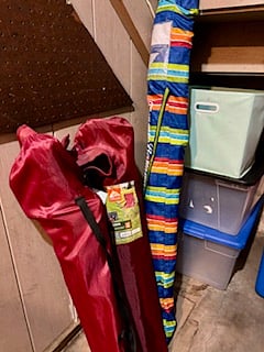 Stored in the utility closet of the unit...beach chairs, umbrella, cooler. also included are cleaning supplies, vacuum, mop etc