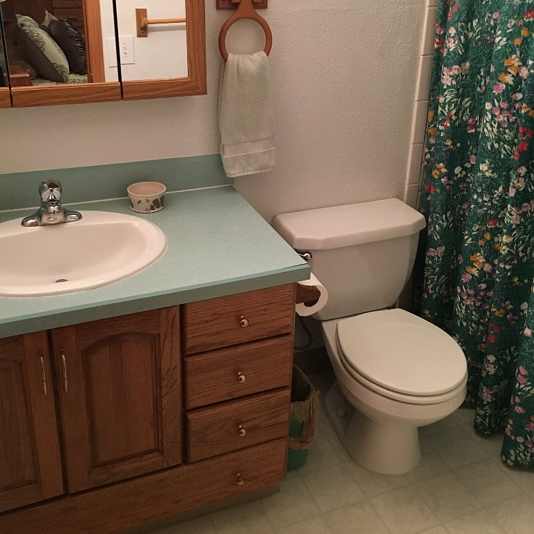 2nd Floor full bathroom has vanity, wall storage shelves, toilet, tub/shower combination.  