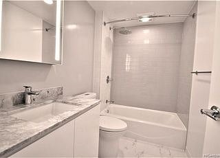 Full bath with towels and hair dryer