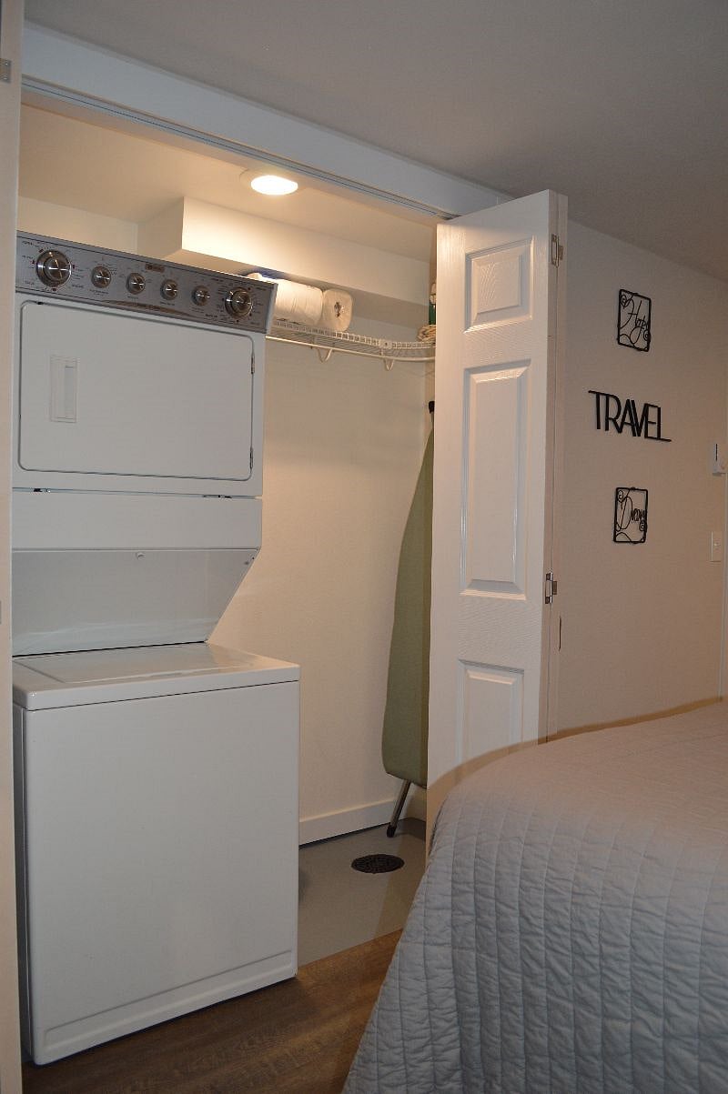 Laundry closet with full size ironing board, iron & supplies