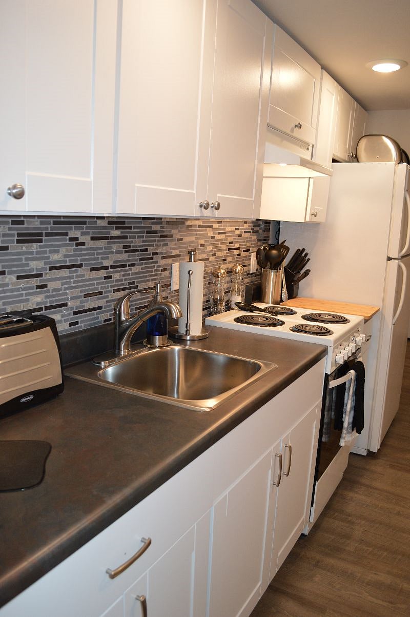 Kitchen with ample storage, range & full size refrigerator