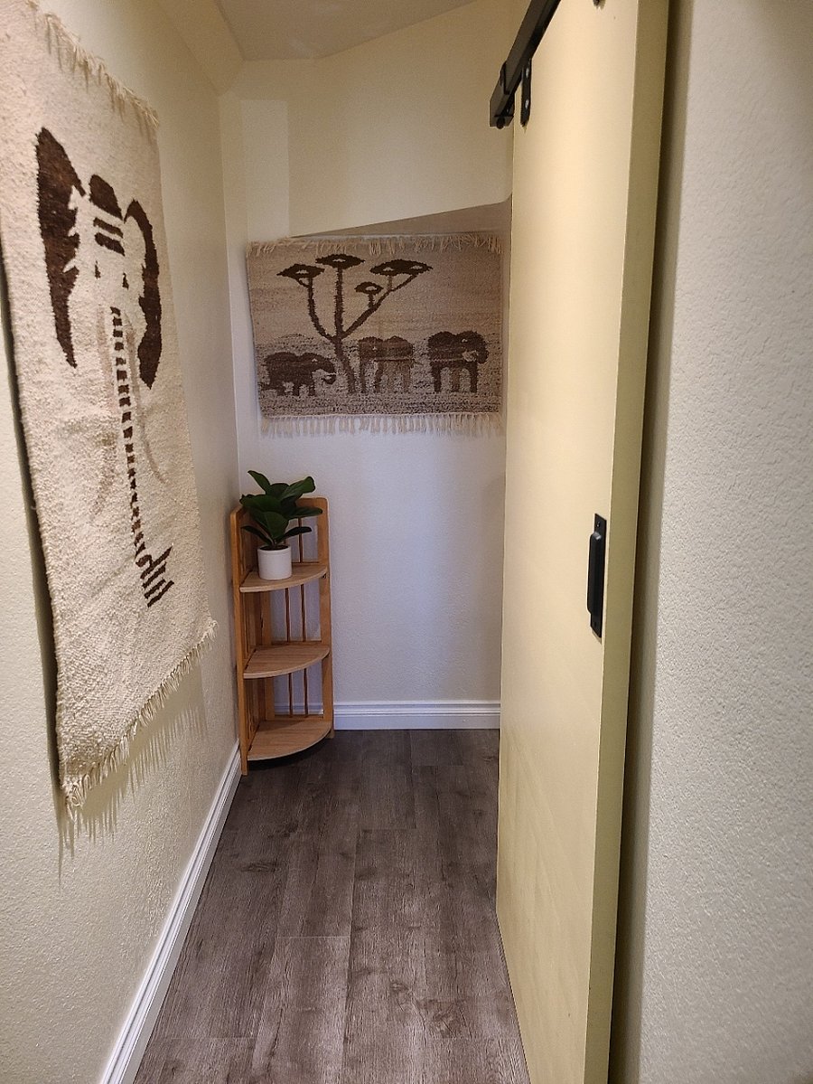 hallway leading to storage on the stairs and under the stairs.