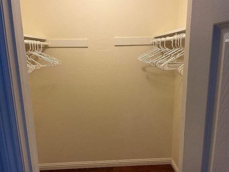 Walk in closet with thirty coat hangers