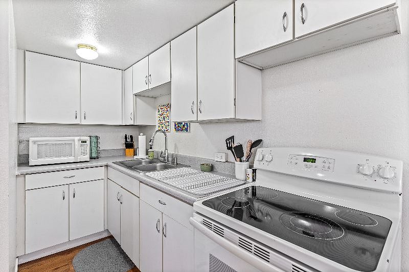 Kitchen with full size refrigerator and oven to meal prep! All kitchen essentials included!