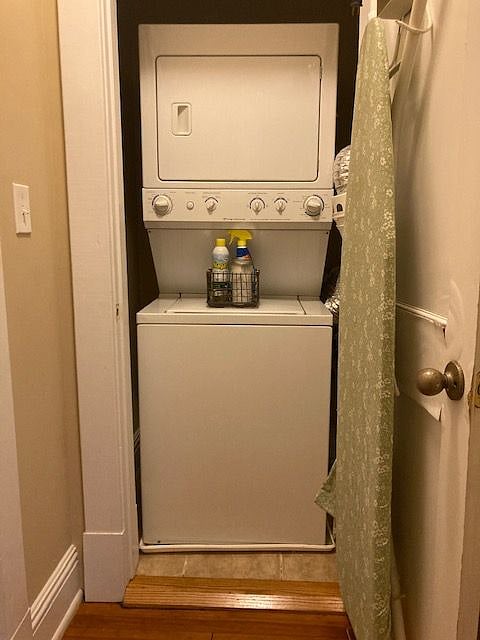 Stacked washer and dryer with full-size ironing board.
