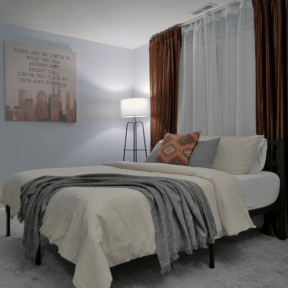 Bedroom 1. Queen size bed with a memory foam mattress. Black-out curtains provide a quiet and comfortable area for anyone needing to rest during day time hours.