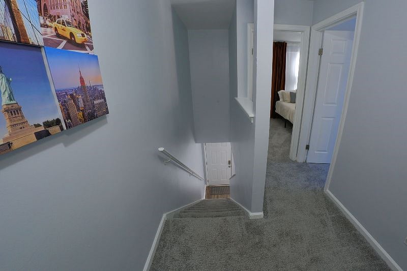 View from the second level down the stairs to the front door. The two bedrooms, full bathroom, and office space are located on this level.