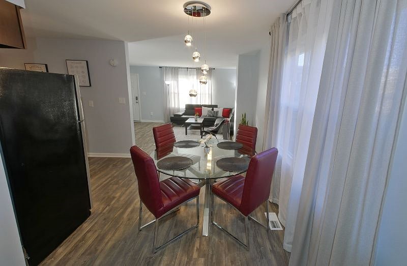 View from the dining area to the living room and front door. The kitchen area is off to the left.