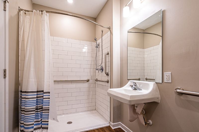 Master Bathroom. The master bathroom is American National Standards Institute (ANSI) compliant.  Shower area allows for wheelchair access and has handheld shower wand.