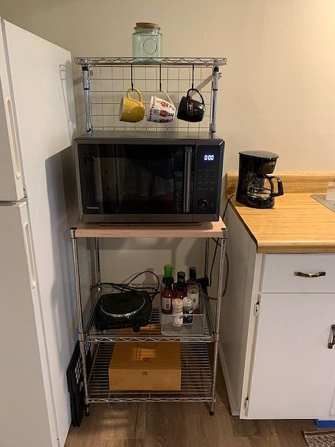Brand new all-in-one microwave, air fryer and oven. Brand new coffee maker. Also in kitchen: hot plate, small crockpot and electric kettle.