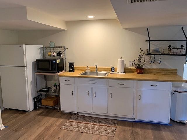 Full size fridge and freezer with ample storage in cabinets and drawers.