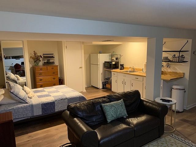 Bonus storage closet with shelving next to fridge.